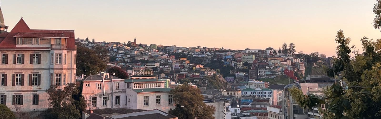The city of Santiago as the sun sets behind it. 